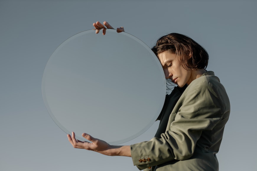 Person holding mirror