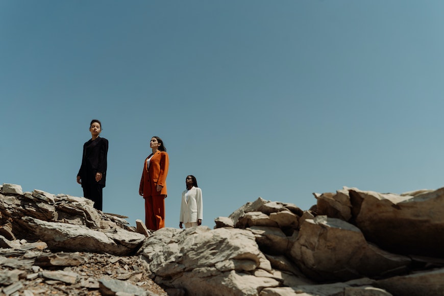 Three people standing on rocks