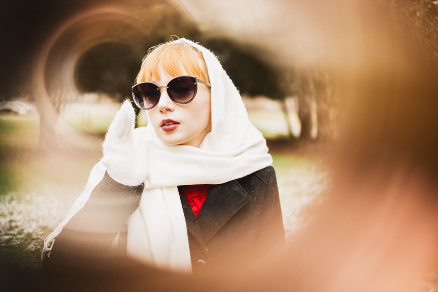 Female model shot through copper pipe